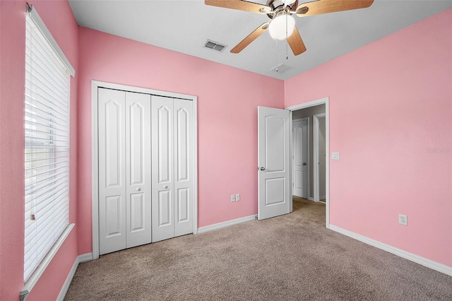 2193 Betsy Ross Ln, Saint Cloud, FL 34769 - unfurnished bedroom featuring carpet flooring, multiple windows, a closet, and baseboards