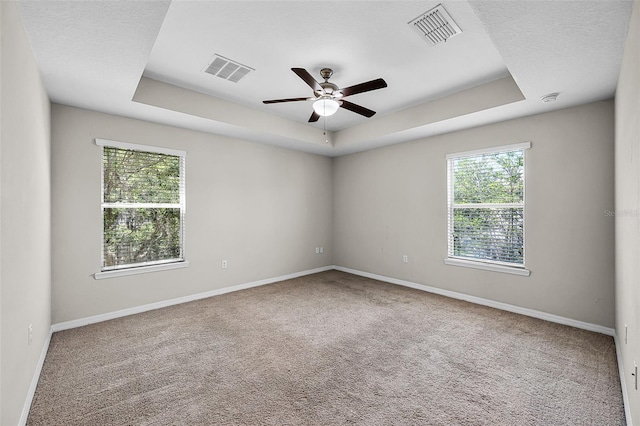 2193 Betsy Ross Ln, Saint Cloud, FL 34769 - carpeted spare room with a tray ceiling, plenty of natural light, a ceiling fan, and baseboards