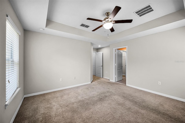 2193 Betsy Ross Ln, Saint Cloud, FL 34769 - unfurnished bedroom featuring carpet floors, baseboards, a raised ceiling, and a ceiling fan