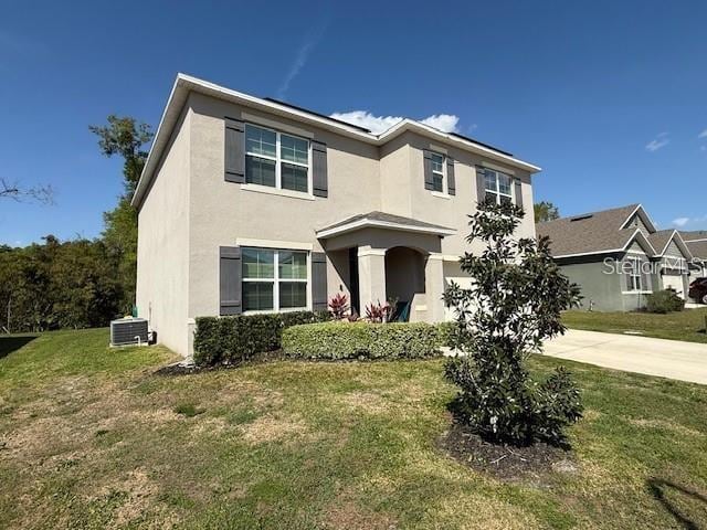6780 Coral Berry Dr, Mount Dora, FL 32757 - traditional-style home with concrete driveway, stucco siding, a front lawn, and central AC unit