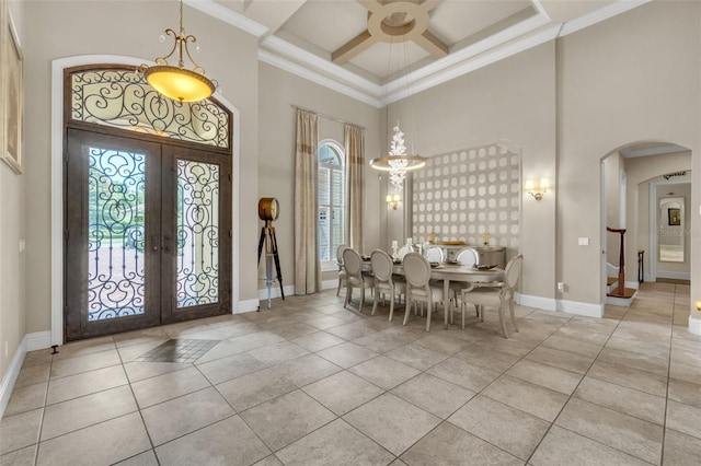 9729 Lake Hugh Dr, Gotha, FL 34734 - entrance foyer featuring a towering ceiling, french doors, arched walkways, healthy amount of natural light, and coffered ceiling