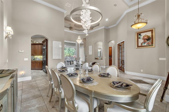 9729 Lake Hugh Dr, Gotha, FL 34734 - dining space featuring arched walkways, a high ceiling, a chandelier, crown molding, and light tile patterned flooring