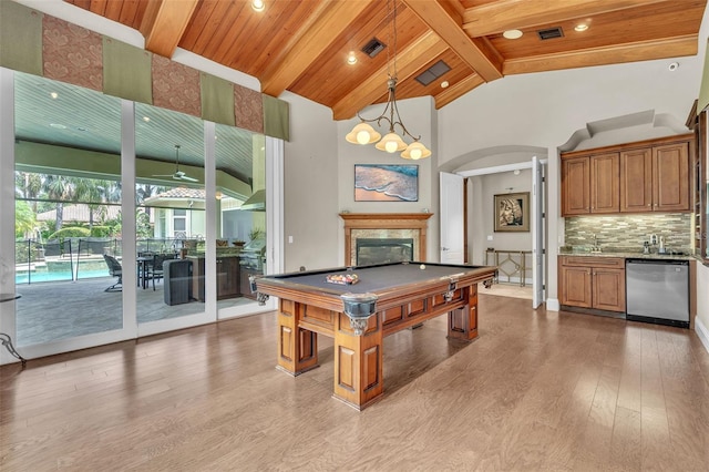 9729 Lake Hugh Dr, Gotha, FL 34734 - rec room with light wood-style flooring, wet bar, high vaulted ceiling, a glass covered fireplace, and billiards