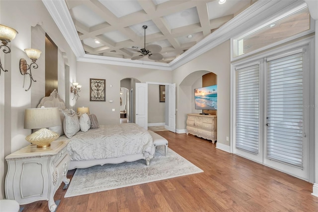 9729 Lake Hugh Dr, Gotha, FL 34734 - bedroom featuring arched walkways, coffered ceiling, beam ceiling, baseboards, and light wood-type flooring
