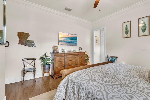 9729 Lake Hugh Dr, Gotha, FL 34734 - bedroom with wood finished floors, crown molding, baseboards, and ceiling fan