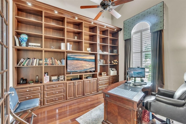 9729 Lake Hugh Dr, Gotha, FL 34734 - home office with a ceiling fan, light wood-style flooring, and built in shelves