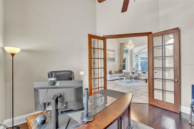 9729 Lake Hugh Dr, Gotha, FL 34734 - office featuring french doors, ceiling fan, wood finished floors, a towering ceiling, and baseboards