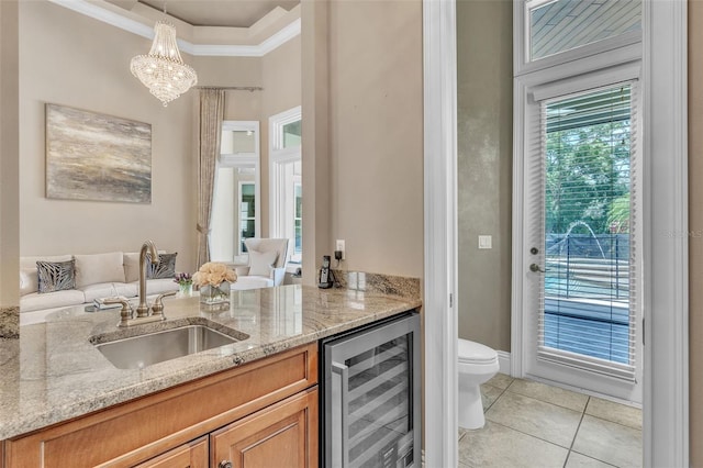9729 Lake Hugh Dr, Gotha, FL 34734 - bar area featuring beverage cooler, a sink, light tile patterned floors, crown molding, and hanging light fixtures