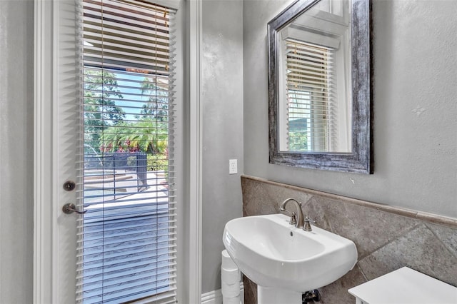 9729 Lake Hugh Dr, Gotha, FL 34734 - bathroom featuring tile walls, wainscoting, and a textured wall