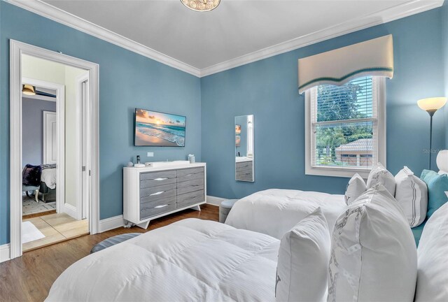 9729 Lake Hugh Dr, Gotha, FL 34734 - bedroom with wood finished floors, crown molding, and baseboards
