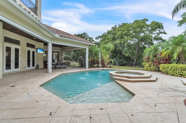 9729 Lake Hugh Dr, Gotha, FL 34734 - view of swimming pool with french doors, a patio, and a pool with connected hot tub