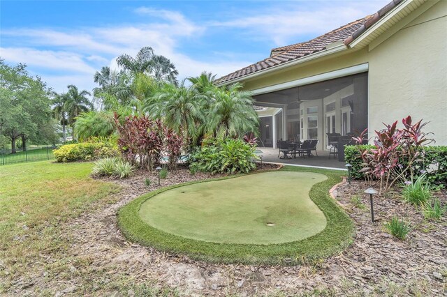 9729 Lake Hugh Dr, Gotha, FL 34734 - view of yard featuring a putting green, a patio area, and a sunroom