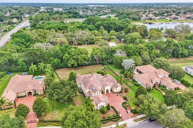 9729 Lake Hugh Dr, Gotha, FL 34734 - aerial view of property and surrounding area featuring a large body of water, nearby suburban area, and a tree filled landscape