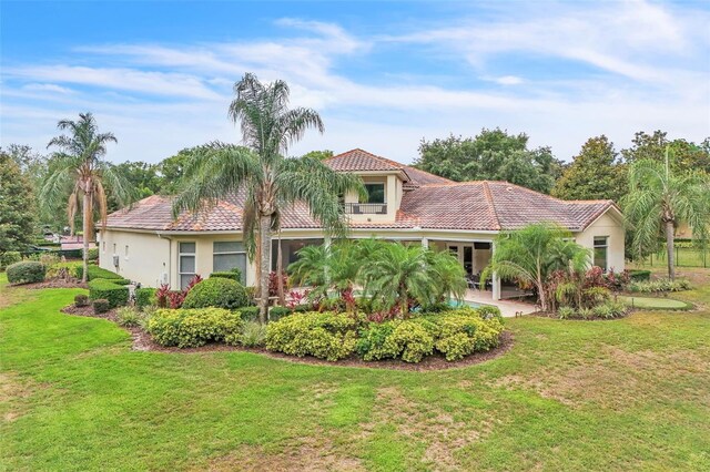 9729 Lake Hugh Dr, Gotha, FL 34734 - mediterranean / spanish home featuring a tiled roof, a front lawn, and stucco siding