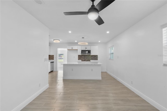 7701 Cassino Ave, Orlando, FL 32819 - kitchen featuring stainless steel appliances, recessed lighting, white cabinets, a ceiling fan, and plenty of natural light