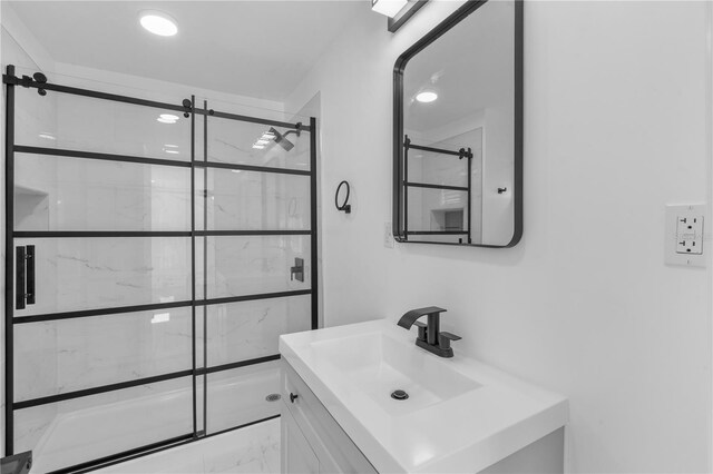 7701 Cassino Ave, Orlando, FL 32819 - full bathroom with marble look tile flooring, a marble finish shower, and vanity