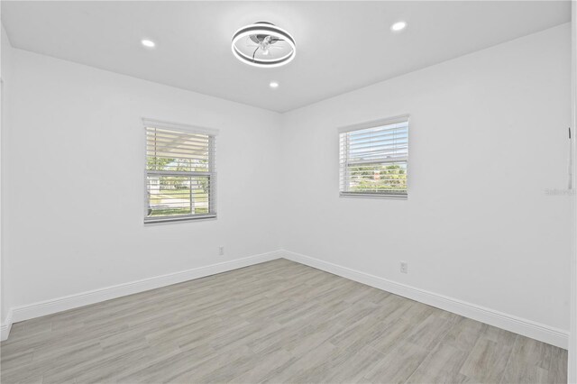 7701 Cassino Ave, Orlando, FL 32819 - spare room featuring baseboards, light wood-type flooring, and recessed lighting