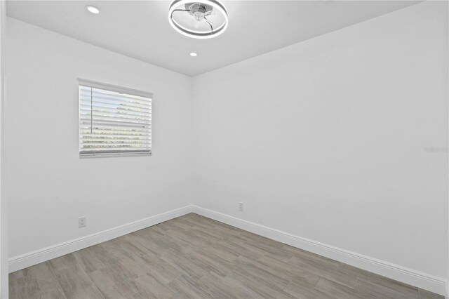 7701 Cassino Ave, Orlando, FL 32819 - unfurnished room featuring wood finished floors, baseboards, and recessed lighting
