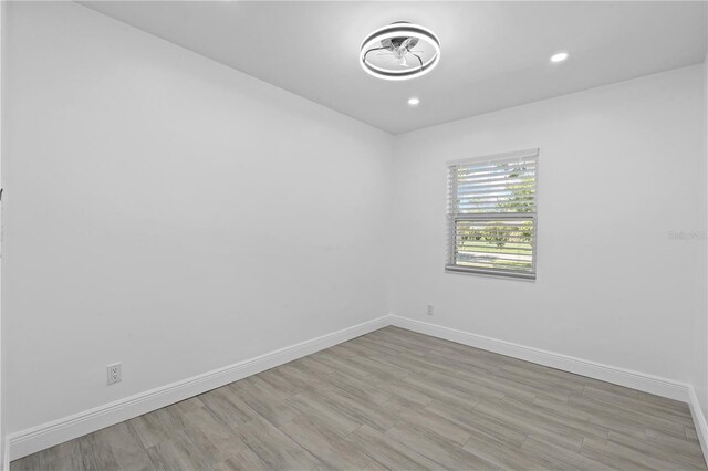 7701 Cassino Ave, Orlando, FL 32819 - empty room featuring baseboards, wood finished floors, and recessed lighting