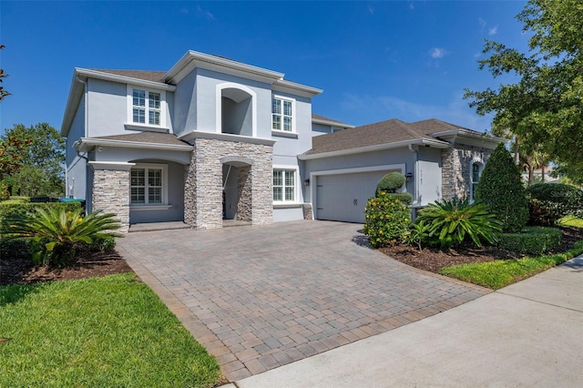 5365 Bowman Dr, Winter Garden, FL 34787 - view of front facade with stucco siding, stone siding, and a garage