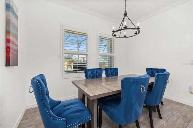 5365 Bowman Dr, Winter Garden, FL 34787 - dining area with a chandelier, wood finished floors, baseboards, and crown molding
