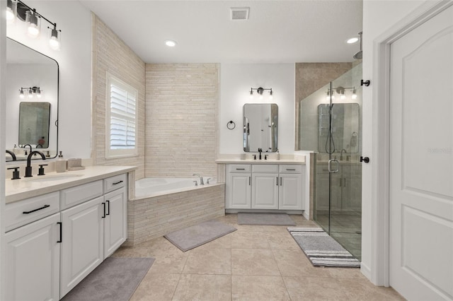 5365 Bowman Dr, Winter Garden, FL 34787 - bathroom with a shower stall, two vanities, a garden tub, tile patterned flooring, and recessed lighting