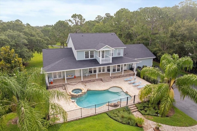 1550 Bluewater Run, Chuluota, FL 32766 - rear view of house with a fenced backyard, a wooded view, and french doors