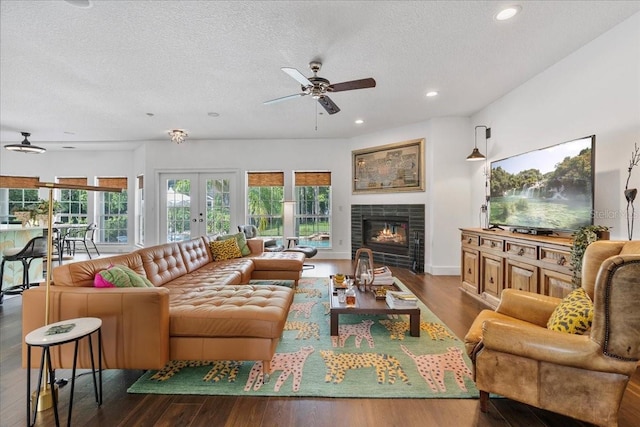 1550 Bluewater Run, Chuluota, FL 32766 - living area with ceiling fan, wood finished floors, a textured ceiling, recessed lighting, and a fireplace