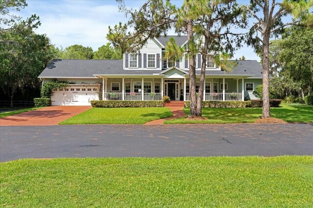 1550 Bluewater Run, Chuluota, FL 32766 - view of front of home featuring a porch, a front lawn, and an attached garage