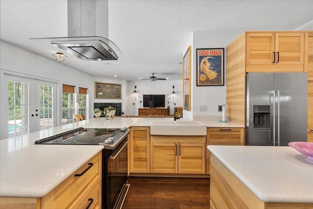1550 Bluewater Run, Chuluota, FL 32766 - kitchen with high end refrigerator, black range with electric stovetop, island range hood, open floor plan, and a textured ceiling
