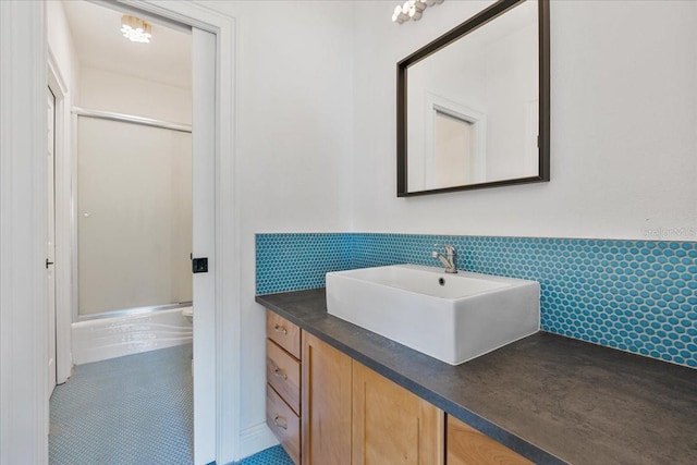 1550 Bluewater Run, Chuluota, FL 32766 - full bath with a shower with shower door, vanity, wainscoting, tile walls, and tile patterned floors