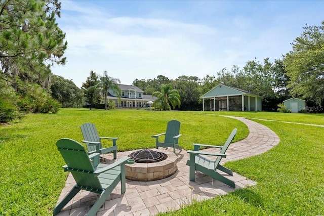 1550 Bluewater Run, Chuluota, FL 32766 - view of grassy yard with an outdoor fire pit, a patio area, and an outbuilding