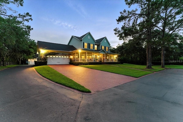 1550 Bluewater Run, Chuluota, FL 32766 - view of front facade with decorative driveway, a porch, a front yard, and an attached garage
