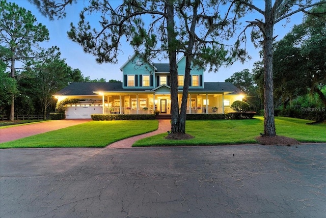 1550 Bluewater Run, Chuluota, FL 32766 - view of front facade featuring driveway, a front lawn, an attached garage, and covered porch