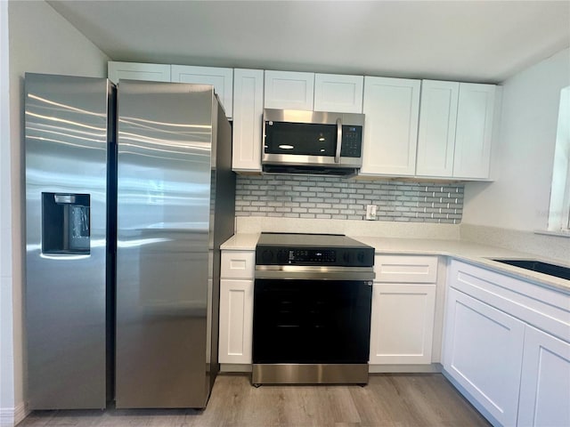 804 Starke Lake Cir, Ocoee, FL 34761 - kitchen with stainless steel appliances, light wood-type flooring, white cabinetry, and light countertops