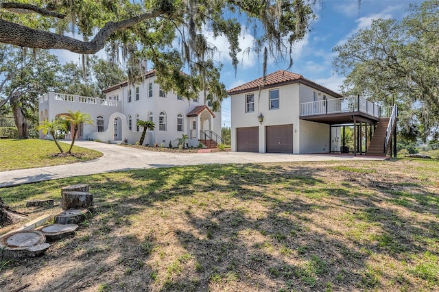 802 S 10th St, Haines City, FL 33844 - view of front of home with stucco siding, stairway, a garage, driveway, and a tiled roof