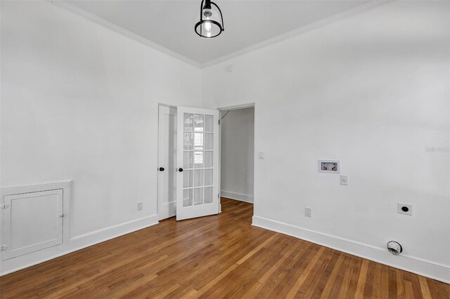 802 S 10th St, Haines City, FL 33844 - empty room with baseboards, crown molding, wood finished floors, and french doors