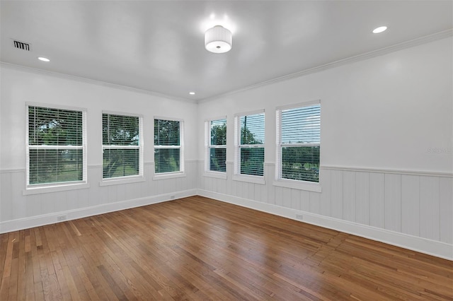 802 S 10th St, Haines City, FL 33844 - empty room with wood-type flooring, ornamental molding, and a wainscoted wall