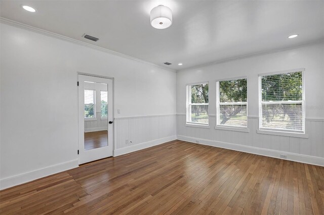 802 S 10th St, Haines City, FL 33844 - empty room with wood-type flooring, crown molding, wainscoting, recessed lighting, and baseboards