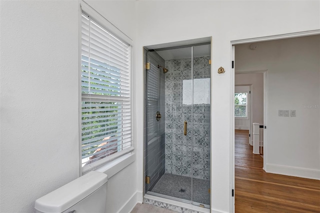 802 S 10th St, Haines City, FL 33844 - bathroom with toilet, a shower stall, wood finished floors, and baseboards