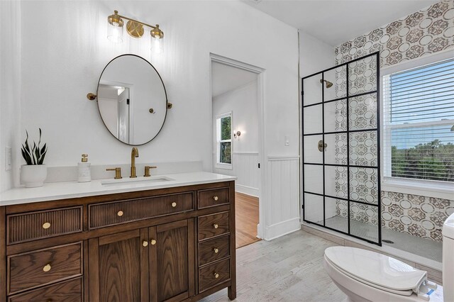 802 S 10th St, Haines City, FL 33844 - bathroom featuring healthy amount of natural light, wood finished floors, tiled shower, and wainscoting