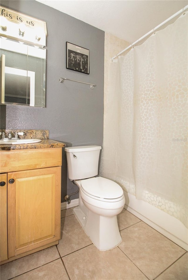 610 Heatherton Vlg Unit 610, Altamonte Springs, FL 32714 - bathroom with toilet, vanity, tile patterned floors, and shower / tub combo
