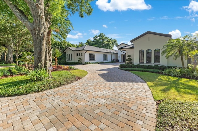 5157 Latrobe Dr, Windermere, FL 34786 - view of front of house with curved driveway, stucco siding, and a front yard