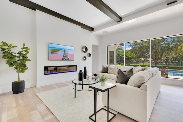 5157 Latrobe Dr, Windermere, FL 34786 - living area with beamed ceiling, wood finished floors, a glass covered fireplace, and baseboards