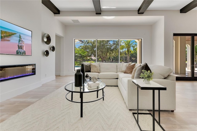 5157 Latrobe Dr, Windermere, FL 34786 - living room featuring beamed ceiling, light wood finished floors, baseboards, and a glass covered fireplace