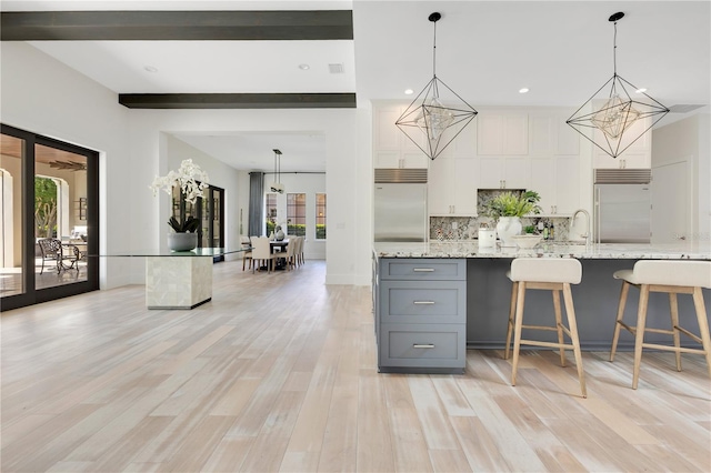 5157 Latrobe Dr, Windermere, FL 34786 - kitchen with built in fridge, gray cabinetry, tasteful backsplash, white cabinets, and recessed lighting