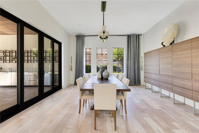 5157 Latrobe Dr, Windermere, FL 34786 - dining space featuring light wood-style flooring, french doors, baseboards, and a chandelier