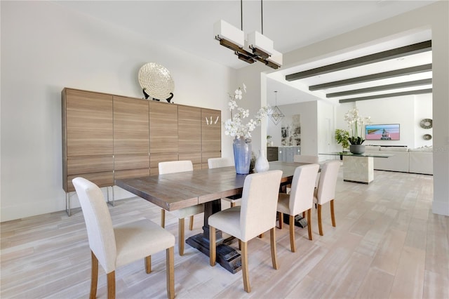 5157 Latrobe Dr, Windermere, FL 34786 - dining space with beamed ceiling, a chandelier, and light wood-style floors