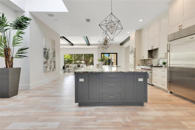 5157 Latrobe Dr, Windermere, FL 34786 - kitchen featuring high end appliances, light wood finished floors, tasteful backsplash, gray cabinetry, and recessed lighting