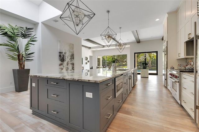 5157 Latrobe Dr, Windermere, FL 34786 - kitchen with a chandelier, high end appliances, gray cabinetry, a large island with sink, and a sink